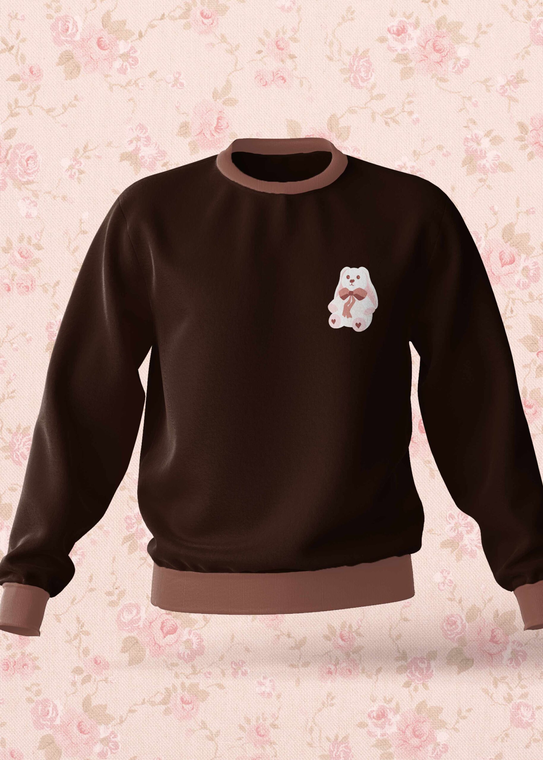 Brown sweatshirt with a small cartoon rabbit on the chest.
